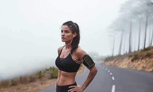 Confident young female athlete on outdoor training
