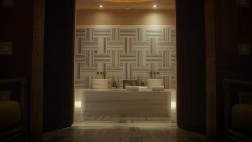 Empty luxurious and traditional hammam spa room with marble and ornate tiling for relaxation and wellness