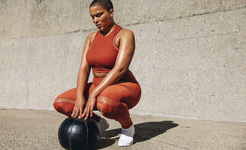 Healthy woman exercising with medicine ball
