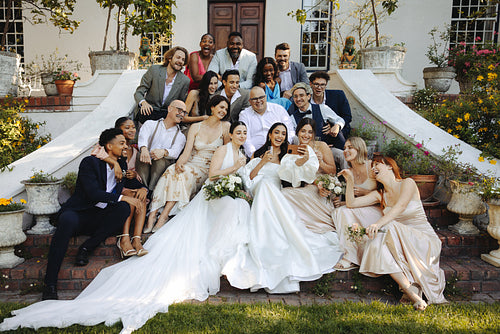Two brides celebrating with family and friends on wedding day outdoors