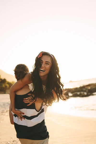 Tourist couple in playful mood on beach
