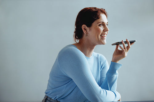 Female entrepreneur making a phone call in a corporate workplace