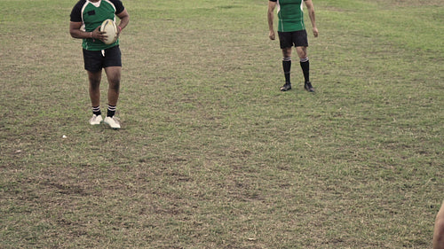 Rugby players tackling during a game