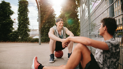 Streetball players taking rest after playing a game.