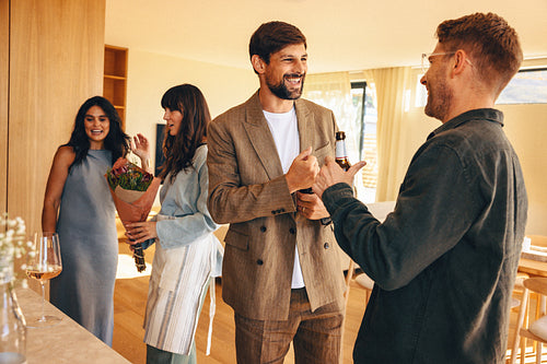 Group of friends enjoying a casual meetup inside a cozy, modern home