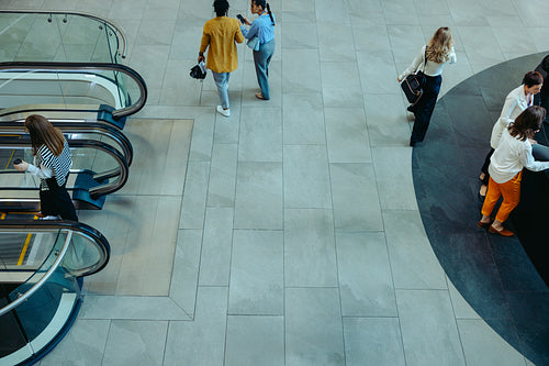 Corporate workplace lobby environment with professionals engaged in business activities