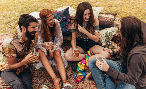 Friends hanging out with beers at music festival