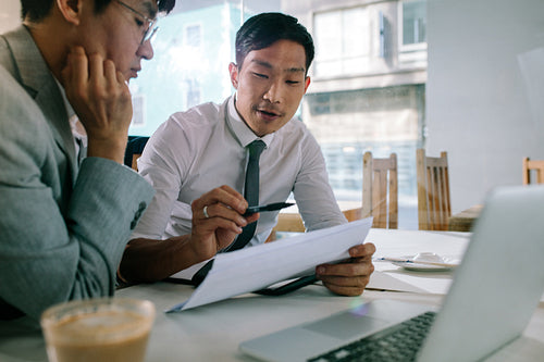 Business professionals discussing over some paperwork
