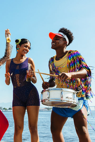 Carnival party scene with dancers and drummer