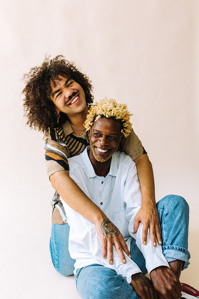 LGBTQ+ couple posing in a studio