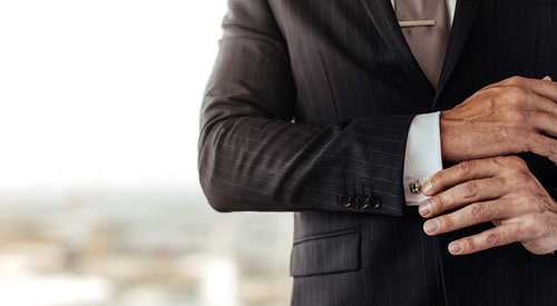 Businessman adjusting his cufflinks