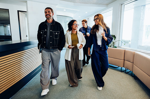 Group of diverse professionals walking through office