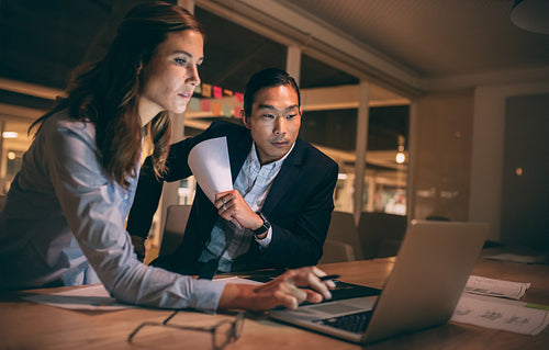 Business colleagues working late in the night at office