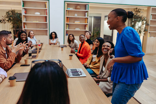 Diverse team engaged in a lively discussion during a business meeting