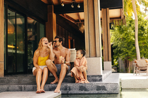 Happy family sharing ice cream cones on a relaxing vacation
