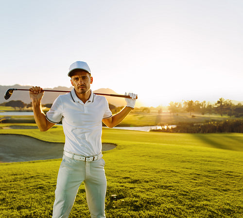 Professional golfer with golf club at course