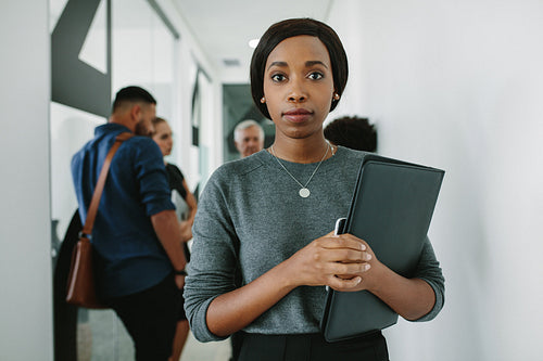 Confident african woman in office hallway