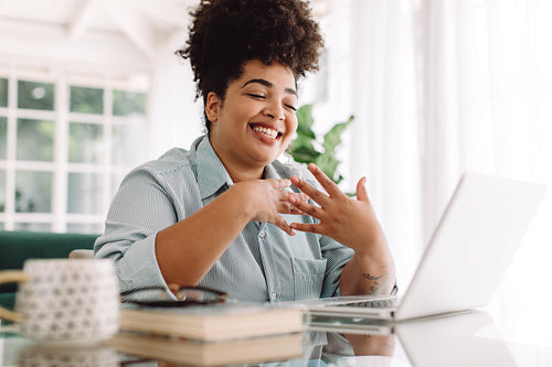 Businesswoman at home video calling on laptop