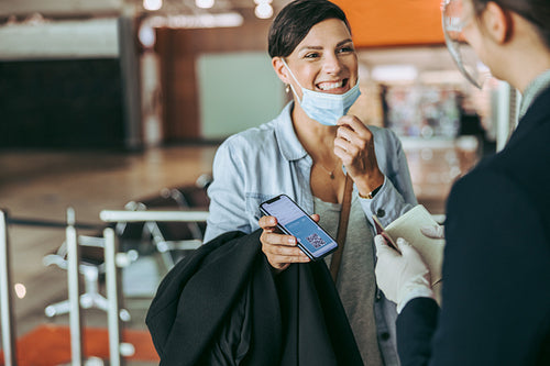 Woman checking in at airport with medical pass
