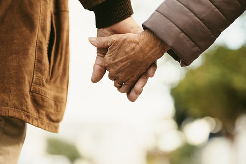 Together forever - Old couple walking hand in hand