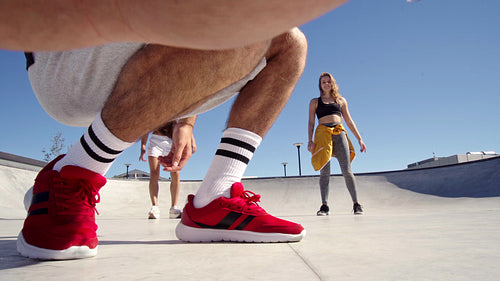 Three happy shatters taking a picture together in a skate park