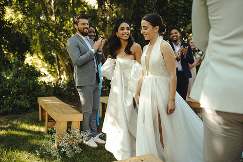 Beautiful outdoor wedding showcasing a loving lgbt couple and happy guests celebrating together