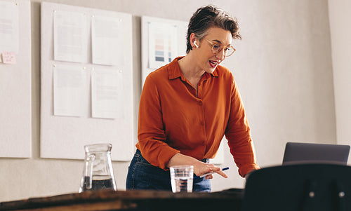 Mature businesswoman talking to her client during a video conference