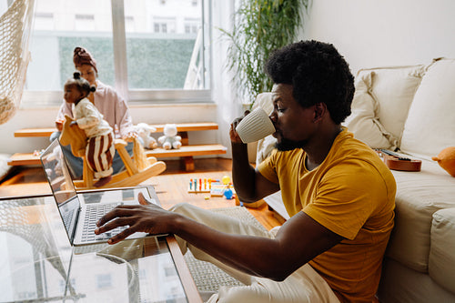 Man working from home with family at play