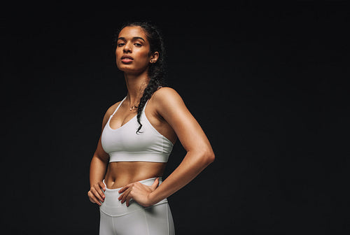 Portrait of fit woman on black background