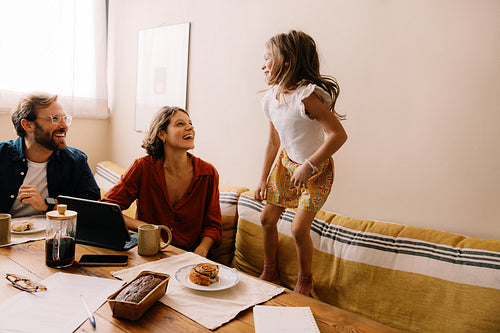 Family scene with parents and child dancing