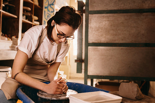Female potter making clay pot