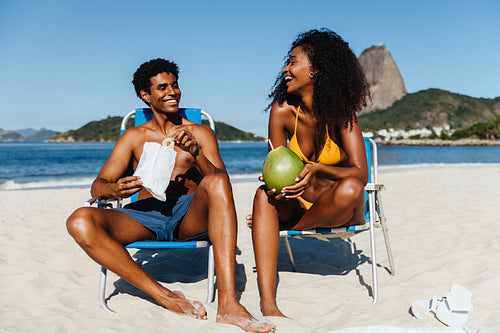 Two friends enjoying a sunny day on a beautiful beach in Brazil