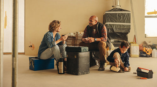 Family enjoying a coffee break during a DIY home renovation project