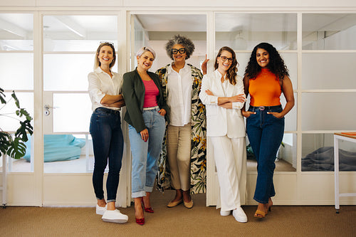 Successful businesswomen smiling at the camera in an office
