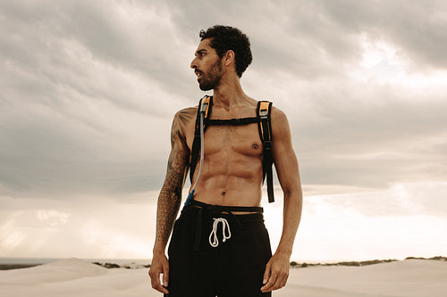 Muscular man taking a break from workout