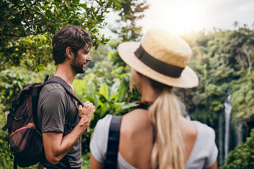 Young man standing with his girlfriend in forest