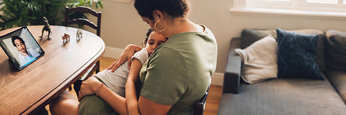 Doctor having telemedicine with family at home