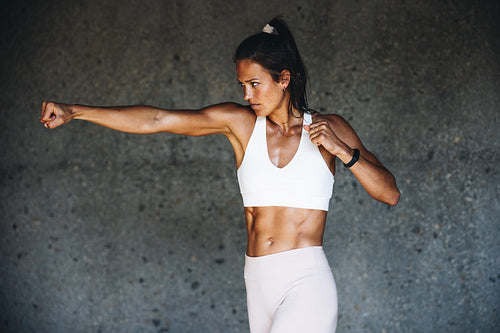 Sportswoman doing shadow boxing exercise