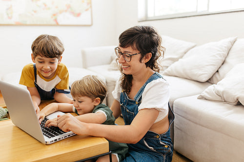 Family having fun while using laptop computer