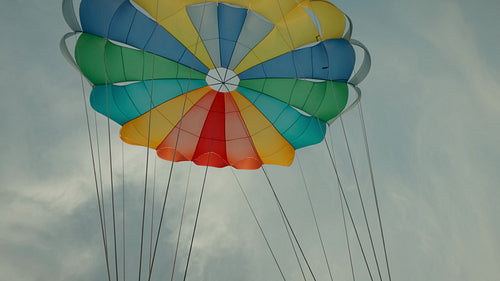 Parasailing high above the calm ocean as the sun sets, creating a serene adventure