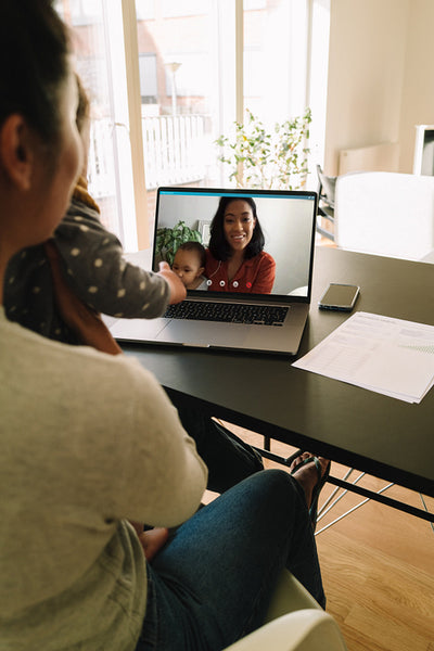 Mother and daughter having video chat with family