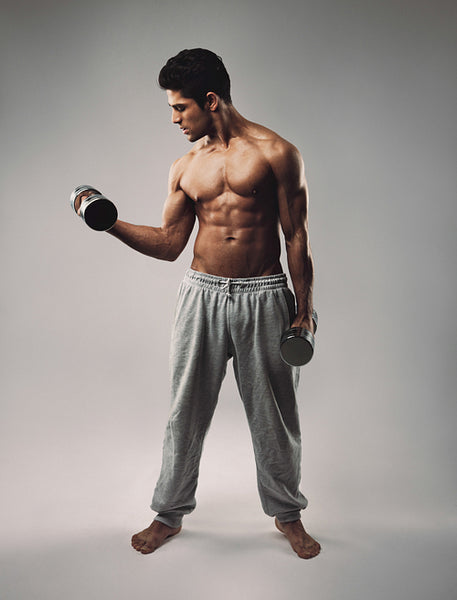 Muscular young man exercising with dumbbells