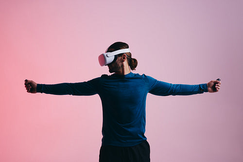 Young man playing a 3D shooting game