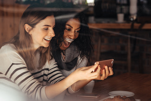 Friends in a cafe taking a selfie