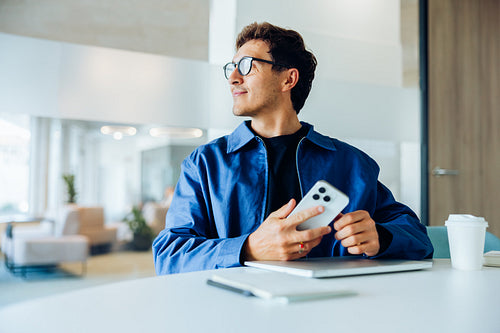 Man uses smartphone in office
