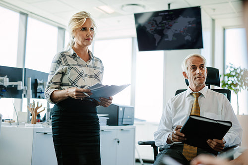 Caucasian business colleagues in office looking away