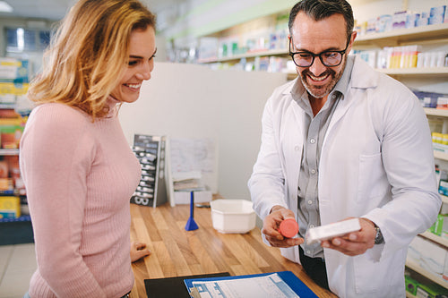 Pharmacist suggesting medical drug to buyer