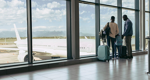 Family waiting for their flight at airport