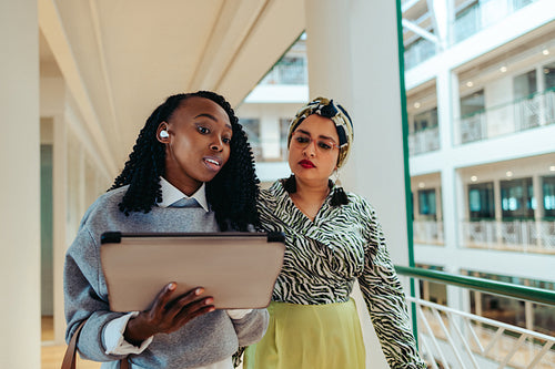 Multicultural colleagues collaborating in modern office