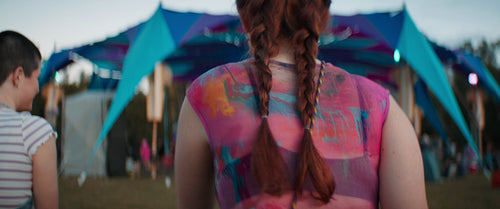 Three excited girlfriends running to music festival dance floor